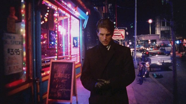 Tom Cruise appears in front of a rear-projected cityscape scene in this shot from  Eyes Wide Shut  (1999)